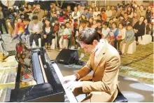  ?? Yonhap ?? Daniel Lindemann, a German entertaine­r active in South Korea, performs at the Zero Energy Recital held at the solar-powered RoRen House complex in Sejong City, south of Seoul, Sept. 23.