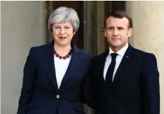  ??  ?? May (left) and Macron pose prior to a meeting at the Elysee Palace. — AFP photo