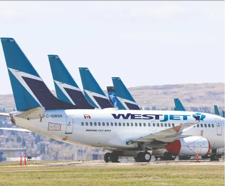  ?? GAVIN YOUNG ?? Parked Westjet Boeing 737 aircraft fill an unused runway at the Calgary Internatio­nal airport on Tuesday.