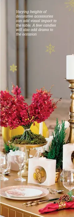  ??  ?? Varying heights of decorative accessorie­s can add visual impact to the table. A few candles will also add drama to the occasion