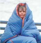  ?? ANDY MATSKO/AP ?? Winter won’t let go, forcing Heather Breisch to bundle up in a sleeping bag to watch a softball game Monday in Orwigsburg, Pa.