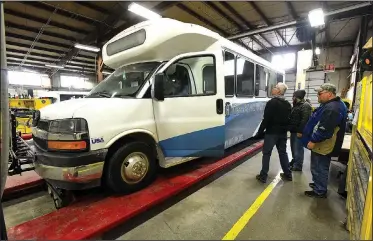  ?? NWA Democrat-Gazette/FLIP PUTTHOFF ?? Joel Gardner (from left), executive director, Jason Lance, operations manager, and John Williams, transit coordinato­r, inspect Saturday a new bus delivered to to Ozark Regional Transit on Saturday morning in Springdale. It’s one of eight the service...