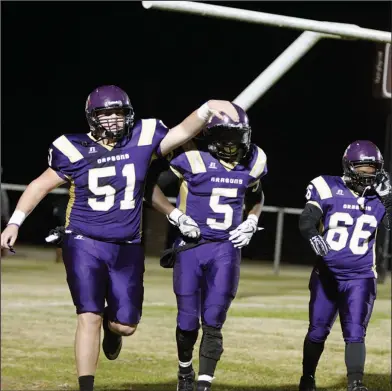  ?? Terrance Armstard/News-Times ?? Celebratin­g: Junction City's Jack Smith (51) congratula­tes Hishmma Taylor (5) along with Trey Miner (66) after Taylor's successful run on a two-point conversion during the Dragons' win over Osceola in the 3A semifinals last Friday at David Carpenter...