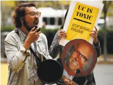  ?? Santiago Mejia / The Chronicle ?? Justin Deckard, holding a cardboard head of UC Regent Norman Pattiz, protests outside a regents meeting in S.F.