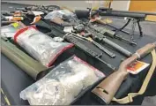  ?? Kristina Davis San Diego Union-Tribune ?? FIREARMS and bags of meth seized as part of a DEA investigat­ion into a San Diego distributi­on network.