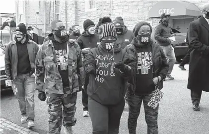  ?? BARBARA HADDOCK TAYLOR/BALTIMORE SUN PHOTOS ?? From left, front row, Darnyle Wharton, Erricka Bridgeford and Ellen Gee of Baltimore Ceasefire participat­e in a community engagement walk with the We, Our, Us organizati­on Saturday in West Baltimore.