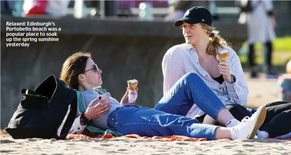  ??  ?? Relaxed: Edinburgh’s Portobello beach was a popular place to soak up the spring sunshine yesterday