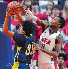  ?? SEAN D. ELLIOT/THE DAY ?? NFA’s Max Pierre Louis blocks a shot attempt by Ledyard’s Dorell Cagle during Tuesday night’s ECC Division I boys’ basketball final at Mohegan Sun Arena. NFA remained unbeaten with a 54-43 win.