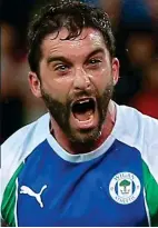  ??  ?? On song: Grigg after his penalty