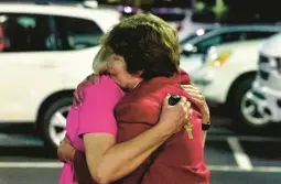  ?? BUTCH DILL/AP ?? Saint Stephen’s Episcopal Church members console each other Thursday after a shooting at the church in Vestavia Hills, Alabama. An unnamed suspect is in custody.
