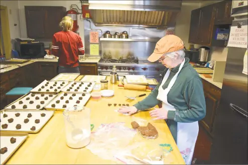 ?? H John Voorhees III / Hearst Connecticu­t Media ?? BJ Liberty, right, and Jill Anderson, both of Bethel, bake cookies for the St. Thomas Episcopal Church annual Homemade Holiday Cookie Sale. They will bake 14 varieties of cookies, in the churches kitchen, which will be sold by the pound at the church on Saturday from 9:30 a.m. to noon.