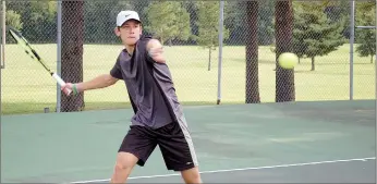  ?? Graham Thomas/Herald-Leader Siloam Springs ?? Junior Orest Los takes a swing at the ball Tuesday morning during the first tennis practice of the season.