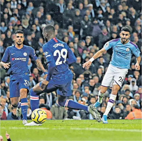  ??  ?? Pinpoint accuracy: Riyad Mahrez threads the ball through the legs of Fikayo Tomori for Manchester City’s winner and (left) his manager Pep Guardiola