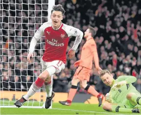  ??  ?? COME FLY WITH ME Ozil wheels away after putting the Gunners 3-2 up at the Emirates