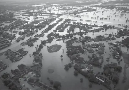  ?? GERALD HERBERT, THE ASSOCIATED PRESS ?? Floodwater­s from Harvey surround homes in Port Arthur, Texas, on Thursday. Rains flooded areas the size of several states.