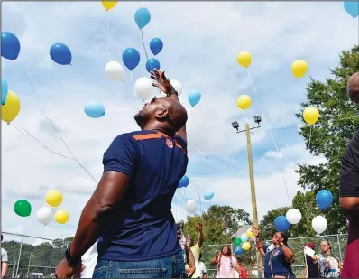  ?? ?? Community members release balloons Oct. 2 in memory of Tramaris Bryant, Tyrone Brooks and Andrew Bryant at the basketball courts of the Covington Recreation Center in Opelika, Ala.
(AP/Opelika-Auburn News/Alex Hosey)