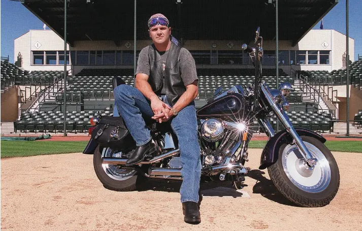  ?? Helen H. Richardson, The Denver Post ?? Larry Walker, the 1997 National League MVP, poses at spring training in 1998 with the Harley Davidson the Rockies presented to him.