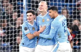  ?? Photo — AFP ?? Haaland (centre) celebrates with Julian Alvarez (left) and Matheus Nunes after scoring their third goal during the UEFA Champions League round of 16, second-leg, football match between Manchester City and FC Copenhagen.