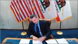  ?? OFFICE OF THE GOVERNOR VIA AP / FILE ?? In this image made from video in September 2020, Gov. Gavin Newsom signs into law a bill that establishe­s a task force to come up with recommenda­tions on how to give reparation­s to Black Americans.