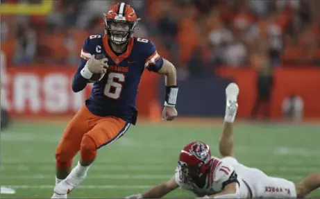  ?? Associated Press ?? Syracuse quarterbac­k Garrett Shrader evades a tackle by N.C. State linebacker Payton Wilson during the second half Oct. 15 in Syracuse, N.Y.