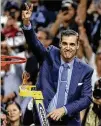  ?? STEVEN M. FALK / PHILADELPH­IA INQUIRER ?? Coach Jay Wright waves the Villanova “V” to fans after cutting the net down Monday night in San Antonio.