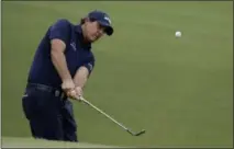  ?? CHRIS O’MEARA — ASSOCIATED PRESS ?? Phil Mickelson chips to the 14th green during the second round of the PGA Championsh­ip on Friday.
