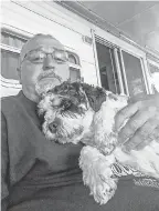  ?? PROVIDED BY RON PACKARD ?? Dominic with owner Ron Packard two weeks before the 5- year- old cavachon died. The dog had recently started wearing a collar.