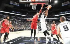  ?? MARK SOBHANI/NBAE/GETTY IMAGES/AFP ?? LaMarcus Aldridge (right) of the San Antonio Spurs shoots against the Toronto Raptors on Tuesday.