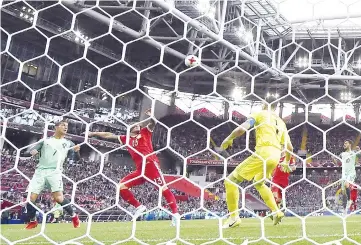  ?? - AFP photo ?? Portugal’s forward Cristiano Ronaldo (L) heads the ball to score past Russia’s goalkeeper Igor Akinfeev (R) during the 2017 Confederat­ions Cup group A football match between Russia and Portugal at the Spartak Stadium in Moscow on June 21, 2017.