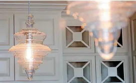  ??  ?? Left: Light fixtures make the kitchen shine at 704 Timber Trail.
Below: The great room ceiling at 704 Timber Trail in Norman.