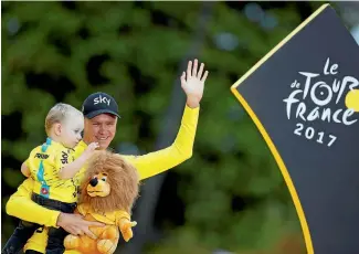  ?? PHOTO: REUTERS ?? Chris Froome celebrates his fourth Tour win with son Kellan.