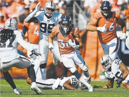  ?? Andy Cross, The Denver Post ?? Broncos undrafted rookie running back Phillip Lindsay is providing more bang for the buck than quarterbac­k Case Keenum or wide receiver Demaryius Thomas, who combine to make up $27 million of the team’s salary.