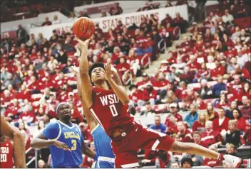  ?? YOUNG KWAK/AP ?? WASHINGTON STATE FORWARD JAYLEN WELLS (0) shoots during the second half of a game against UCLA on March 2 in Pullman, Wash.