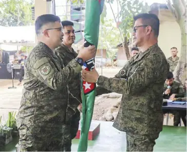  ?? ?? Newly installed 62nd Infantry Battalion (62IB) commander Lieutenant Colonel Evelio C. Ilanga III (left) receives the 62IB flag from 3rd Infantry Division commander Major General Marion R. Sison (right) during a turnover ceremony on Tuesday, Feb. 27.