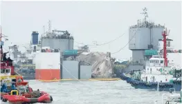  ?? — AFP ?? Semi-submersibl­e ship the ‘Dockwise White Marlin’ is positioned beneath the wreck of the Sewol ferry off the coast of South Korea’s southern island of Jindo on Saturday.