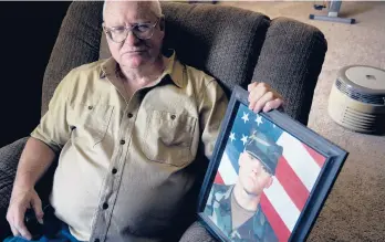  ?? THOMAS PEIPERT/AP ?? Donn Edmunds, a 25-year U.S. Army veteran, sits for a portrait Sept 1 in his living room in Cheyenne, Wyo. Edmunds’ son, Army Ranger Spc. Jonn Edmunds, was among the first U.S. casualties in the Afghanista­n war.