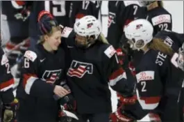  ?? CARLOS OSORIO — THE ASSOCIATED PRESS ?? United States forward Kendall Coyne, left, is greeted by teammates after winning the game’s best player award during an IIHF Women’s World Championsh­ip semifinal against Germany Thursday in Plymouth, Mich.