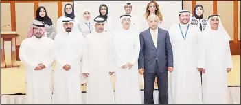  ??  ?? Minister Dr Bader Al-Essa flanked by participan­ts and organizers of the ceremony