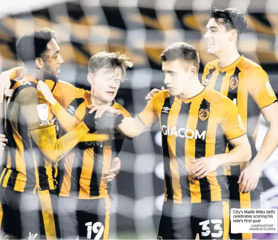  ?? CAMERASPOR­T ANDREW KEARNS ?? City’s Mallik Wilks (left) celebrates scoring his side’s first goal