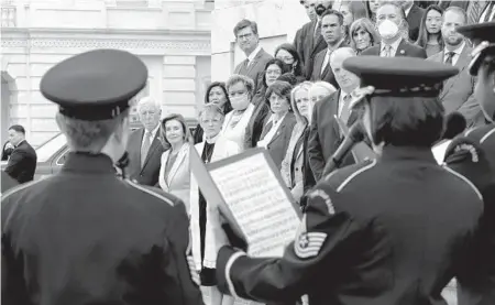  ?? J. SCOTT APPLEWHITE/AP ?? Members of the House stand on the steps of the U.S. Capitol on Thursday during a ceremony to honor the Americans who have died of COVID-19 as the number neared 1 million, a total reached Monday.