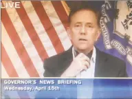  ?? CT-N network feed ?? Gov. Ned Lamont didn’t put on his black mask in a news briefing where he announced mandatory masks, but he had it around his neck and pointed to it.