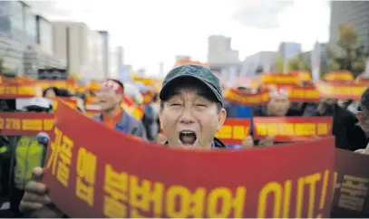  ?? Picture: Reuters ?? SOMETHING TO SCREAM ABOUT. A taxi driver yesterday takes part in a protest against a carpool service applicatio­n that will be launched by Kakao Corp later this year in central Seoul, South Korea. The banners read, ‘Stop carpool service applicatio­n, it is illegal business’.
