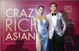  ?? DON WONG — THE ASSOCIATED PRESS ?? Actor Henry Golding and his wife Liv Lo pose as they arrive for the red carpet screening of the movie “Crazy Rich Asians” on Tuesday in Singapore.