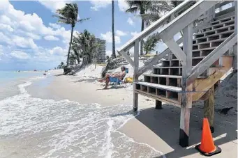  ?? TAIMY ALVAREZ/STAFF PHOTOGRAPH­ER ?? Storms have taken a toll in Dania Beach, leaving just a sliver of sand for beachgoers to enjoy.