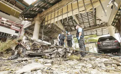  ?? Picture: AFP ?? REFERENDUM RESPONSE. A forensics unit inspects the site of a deadly bomb blast outside a hotel in the southern province of Pattani. Towns have been targeted in a bombing spree recently.