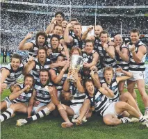  ??  ?? FIRST OF THREE: The victorious Geelong team with the 2007 premiershi­p cup after smashing Port Adelaide.