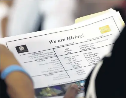  ?? LYNNE SLADKY/AP ?? A job applicant looks at listings at a job fair by Job News South Florida in Sunrise, Fla. The U.S. unemployme­nt rate fell to 3.7 percent in September 2018, the lowest level since December 1969. But a Speak Out commenter questions the low figure.