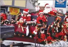  ??  ?? Santa makes an appearance with a couple of his helpers during the Jacksonvil­le Christmas Parade in December 2011. He’ll be making several more parade appearance­s this December in the Three RIvers Edition coverage area.