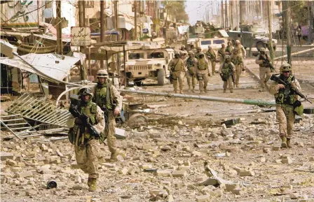  ?? ANJA NIEDRINGHA­US/ASSOCIATED PRESS ?? U.S. Marines push farther west into Fallujah, Iraq, on Nov. 14, 2004. The U.S. military assault captured the city after six days of fighting, a surprise to military officials. There were 31 Americans killed in the siege.