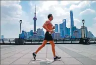  ?? YIN LIQIN / FOR CHINA DAILY ?? A man runs at the Bund in Shanghai at noon on Friday. The temperatur­e in the city reached 40.9 C, a record high.